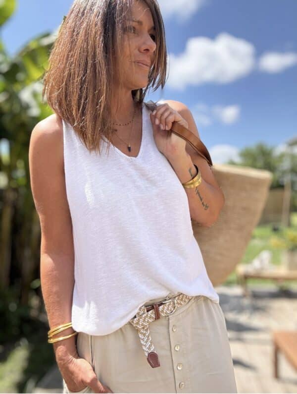 Débardeur blanc fluide en lin Réf. : DB-LIN-BLANC En stock Débardeur blanc fluide en lin, parfait pour l'été. Taille unique (36 à 42), fabrication italienne. Léger, chic et naturel. Description Le débardeur blanc fluide est une pièce essentielle pour la belle saison. Il contient du lin pour une sensation de fraîcheur et une grande légèreté. Sa coupe fluide convient parfaitement du 36 au 42. Il est entièrement fabriqué en Italie, dans des ateliers de qualité. Facile à associer, il s’adapte à tous vos looks : décontracté ou chic. À porter avec un short en jean ou le pantalon Pierre pour un look estival complet. Détails du produit Coloris : Blanc Matière : Mélange de coton et lin Coupe : Fluide Taille unique (du 36 au 42) Fabrication : Italie Style : Décontracté chic Conseil style Associez-le à un short en jean ou au pantalon Pierre beige pour une silhouette naturelle et élégante. #débardeurblanc #linitalien #fabriquéenitalie #lookété #tailleunique