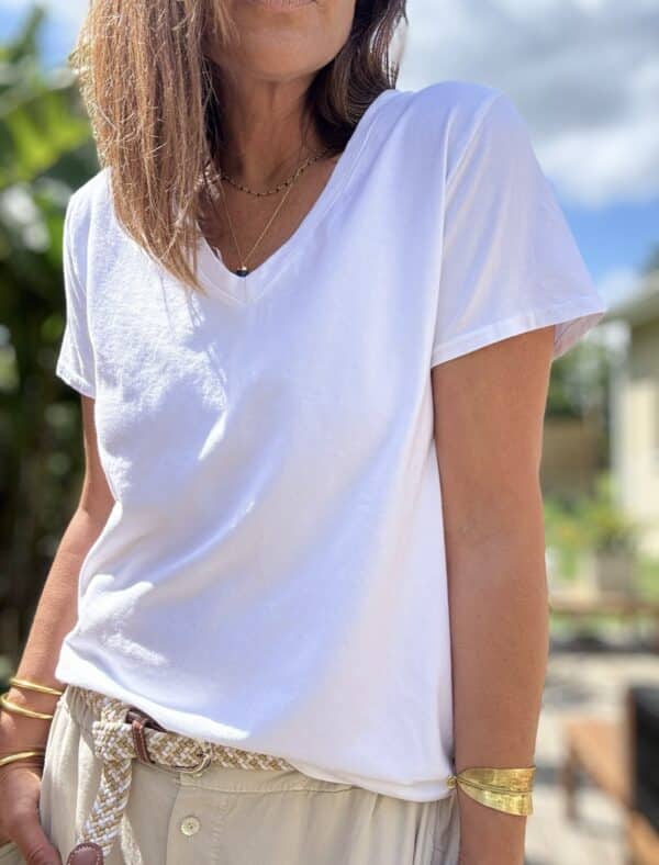 T-shirt col V blanc – Coton et élasthanne Réf. : TSHIRT-V-BLANC En stock T-shirt blanc col V, manches courtes, coupe droite. Composition : 95 % coton, 5 % élasthanne. Taille unique (36 à 42). Fabrication italienne. Description Ce t-shirt blanc est un basique chic et confortable. Son col V met en valeur la silhouette sans effort. La coupe droite et les manches courtes conviennent à toutes. Sa matière douce est composée de 95 % coton et 5 % d’élasthanne. Elle apporte souplesse, confort et respirabilité. La taille unique convient aux morphologies du 36 au 42. Fabriqué en Italie, il allie qualité et finitions soignées. Détails du produit Couleur : Blanc Col : V Manches : Courtes Coupe : Droite Matière : 95 % coton, 5 % élasthanne Taille unique : 36 à 42 Fabrication : Italie Conseil style Associez-le à un jean clair, une jupe fluide ou un pantalon taille haute pour un look simple et efficace. #tshirtblanc #colV #cotoneelasthanne #tailleunique #fabriquéenitalie
