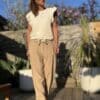 Azélie – Pantalon Camel Léger en Lin et Coton Découvrez Azeli, le pantalon camel pensé pour l’été. Confectionné en 50% coton et 50% lin, il séduit par sa légèreté et son tombé fluide. Sa coupe droite ample convient à toutes les silhouettes. La taille élastique assure confort et maintien sans serrer. En bonus, une ceinture amovible en jute et coton pour un look naturel et raffiné. Ce pantalon dispose de poches pratiques à l’avant et à l’arrière. Sa taille unique convient du 36 au 40. Il est fabriqué en Italie, avec soin et exigence. À associer avec un top léger, un débardeur ou une chemise rentrée. Idéal en ville comme en vacances. Coloris : camel Matière : 50% coton – 50% lin Ceinture amovible (jute & coton) Taille élastique Coupe droite et ample Taille unique : convient du 36 au 42 Fabriqué en Italie