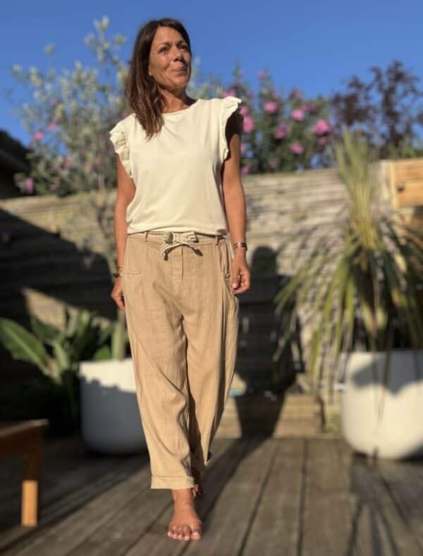 Azélie – Pantalon Camel Léger en Lin et Coton Découvrez Azeli, le pantalon camel pensé pour l’été. Confectionné en 50% coton et 50% lin, il séduit par sa légèreté et son tombé fluide. Sa coupe droite ample convient à toutes les silhouettes. La taille élastique assure confort et maintien sans serrer. En bonus, une ceinture amovible en jute et coton pour un look naturel et raffiné. Ce pantalon dispose de poches pratiques à l’avant et à l’arrière. Sa taille unique convient du 36 au 40. Il est fabriqué en Italie, avec soin et exigence. À associer avec un top léger, un débardeur ou une chemise rentrée. Idéal en ville comme en vacances. Coloris : camel Matière : 50% coton – 50% lin Ceinture amovible (jute & coton) Taille élastique Coupe droite et ample Taille unique : convient du 36 au 42 Fabriqué en Italie