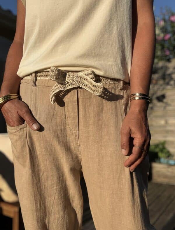 Azélie – Pantalon Camel Léger en Lin et Coton Découvrez Azeli, le pantalon camel pensé pour l’été. Confectionné en 50% coton et 50% lin, il séduit par sa légèreté et son tombé fluide. Sa coupe droite ample convient à toutes les silhouettes. La taille élastique assure confort et maintien sans serrer. En bonus, une ceinture amovible en jute et coton pour un look naturel et raffiné. Ce pantalon dispose de poches pratiques à l’avant et à l’arrière. Sa taille unique convient du 36 au 40. Il est fabriqué en Italie, avec soin et exigence. À associer avec un top léger, un débardeur ou une chemise rentrée. Idéal en ville comme en vacances. Coloris : camel Matière : 50% coton – 50% lin Ceinture amovible (jute & coton) Taille élastique Coupe droite et ample Taille unique : convient du 36 au 42 Fabriqué en Italie