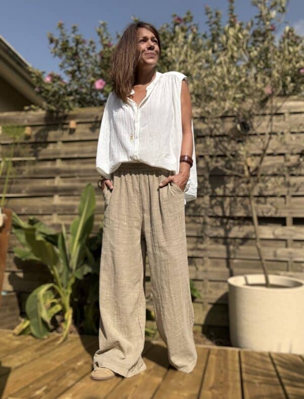 Pantalon Honoré – coton camel – coupe large Craquez pour le pantalon Honoré, un modèle large et fluide, confectionné dans un coton camel léger et agréable à porter. Sa coupe ample assure un style décontracté mais toujours élégant. Il convient parfaitement aux journées actives ou aux moments de détente. La taille élastique s’adapte naturellement à votre silhouette. Elle offre un confort optimal, du matin jusqu’au soir. Ce modèle en taille unique convient aux morphologies allant du 36 au 42. Il s’enfile facilement et épouse les formes sans les contraindre. Les poches latérales ajoutent une touche pratique à ce basique du dressing estival. Vous pouvez y glisser vos essentiels en toute simplicité. Grâce à sa matière légère en coton, ce pantalon reste respirant et agréable à porter même sous les fortes chaleurs. Coupe : Large et fluide Taille : Élastique – convient du 36 au 42 Matière : 100 % coton léger Coloris : Camel Détails : Poches latérales Style : Décontracté, bohème, chic Facile à associer avec une chemise fluide, un t-shirt blanc ou une blouse en lin. Un pantalon pensé pour vous offrir liberté, confort et style en un seul geste. Quantités limitées – ne manquez pas ce basique chic de saison.