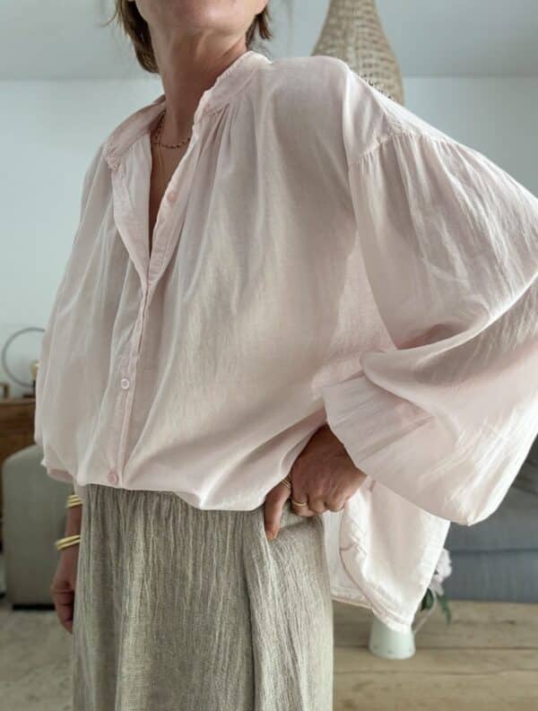 Chemise oversize rose clair en voile de coton – M I Y A Laissez-vous séduire par la douceur et l’élégance de cette chemise rose clair signée M I Y A. Confectionnée en voile de coton, elle offre une sensation de légèreté incomparable. Sa coupe oversize convient à toutes les morphologies, du 36 au 44. Le col Mao apporte une touche moderne et épurée, parfaite pour toutes les occasions. Ses manches longues se ferment par de jolis boutons ton sur ton. Polyvalente, elle se porte ouverte sur un top ou boutonnée avec un pantalon taille haute. Son coloris rose clair illumine le teint et s’associe facilement à des tons neutres ou plus soutenus. Fabriquée en Italie, elle reflète un savoir-faire soigné et durable. 🧵 Composition : 100 % voile de coton 📏 Taille unique (convient du 36 au 44) 🌸 Coloris : rose clair 🇮🇹 Fabrication italienne 👕 Coupe : oversize 👚 Col : Mao 👖 Manches : longues avec bouton