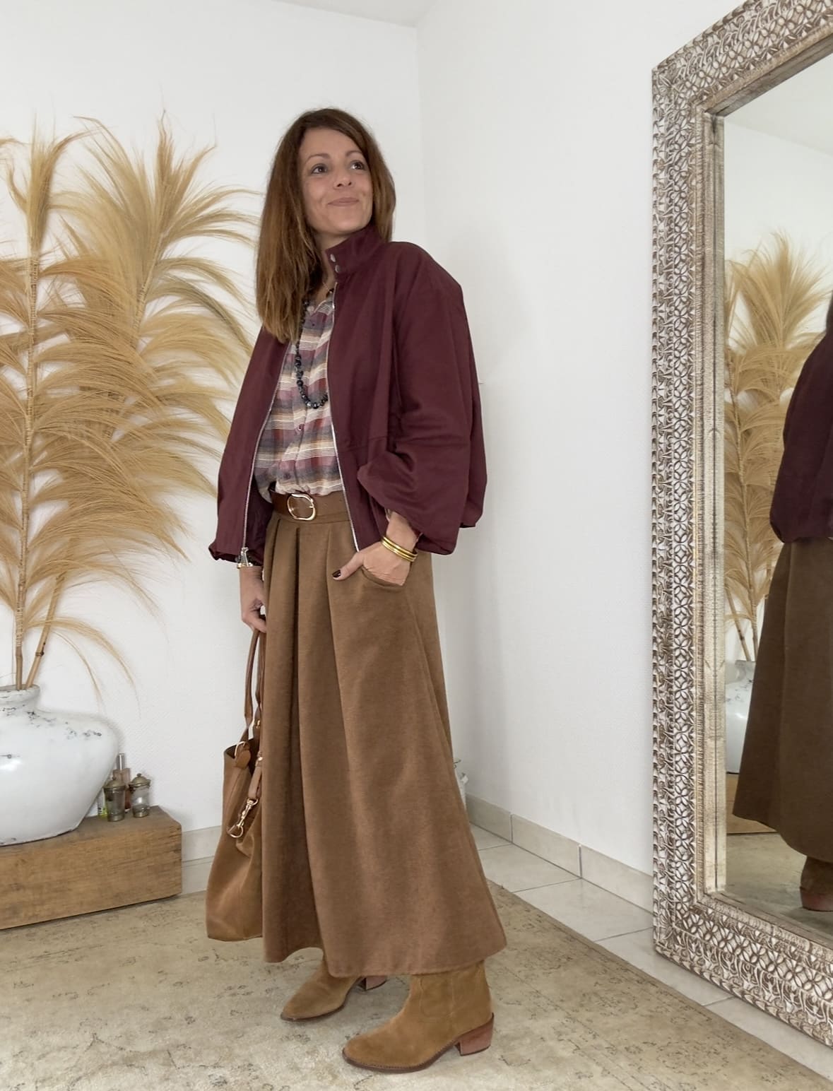 LENAÏC, la veste bordeaux au charme Intuition La veste LENAÏC de la marque Intuition séduit par son équilibre entre confort et élégance. Sa couleur bordeaux profonde attire le regard et valorise le teint. Sa matière douce et fluide épouse la silhouette avec naturel. Entièrement doublée, elle assure un confort agréable et une tenue harmonieuse. Ainsi, LENAÏC devient une pièce incontournable de mi-saison. Une coupe boule plate, féminine et actuelle Sa forme boule plate ajoute du volume sans épaissir la ligne. La silhouette reste souple, moderne et légèrement arrondie. La taille unique convient du 36 au 40 selon le rendu souhaité. De plus, le tombé fluide apporte légèreté et féminité. Cette veste s’adapte aussi bien à un style urbain qu’à une allure bohème. Des détails qui font la différence La fermeture zippée est pratique et élégante. Le bouton du col montant ajoute une touche chic et contemporaine. Les manches, plus longues que trois quarts, libèrent joliment le poignet. Les finitions discrètes témoignent d’un vrai soin de confection. Enfin, la doublure intégrale garantit une structure stable et douce. Un style fluide et des associations parfaites Le coloris bordeaux s’accorde naturellement avec les tons camel, écru ou beige. Cette teinte chaude met en valeur les peaux claires comme dorées. Portez LENAÏC sur un jean pour un look citadin élégant. Elle s’accorde aussi parfaitement avec la jupe Flora et la chemise Namasté, pour un ensemble féminin et harmonieux. Une matière douce et naturelle Confectionnée en 100% coton, LENAÏC allie confort et légèreté. La matière est respirante, agréable et résistante. Elle conserve sa souplesse tout au long de la journée. Ainsi, la veste accompagne chaque mouvement avec fluidité et aisance. En résumé La veste LENAÏC bordeaux Intuition allie modernité, douceur et confort. Sa coupe boule plate et son col montant créent une silhouette élégante. Entièrement doublée, elle s’associe à merveille avec la chemise Namasté et la jupe Flora. Un modèle intemporel et féminin, à adopter sans hésiter.